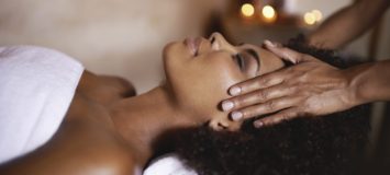 Woman receiving massage at her temples.