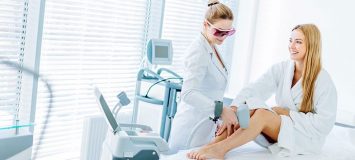 Woman receiving electrolysis treatment on her legs.