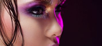 Close-up image of a woman with bright eye makeup.