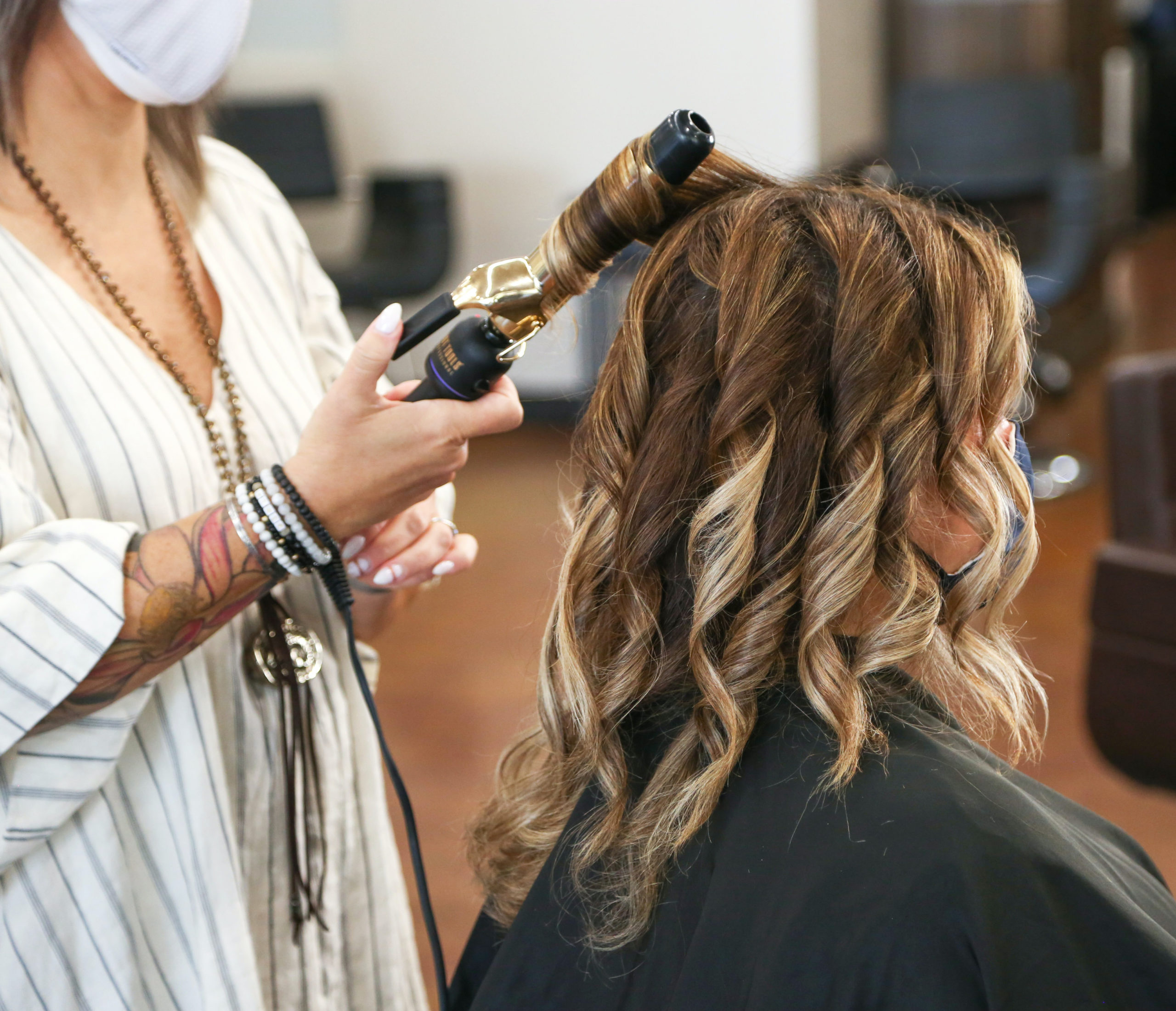 Hair dresser curling client's hair